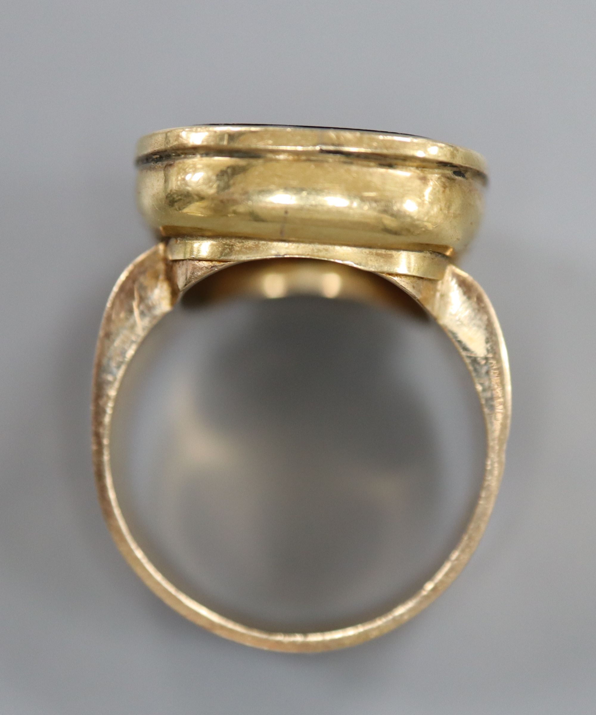 A 9ct and black onyx? intaglio ring, carved with the bust of a gentleman to sinister, size R/S, gross 16.2 grams.